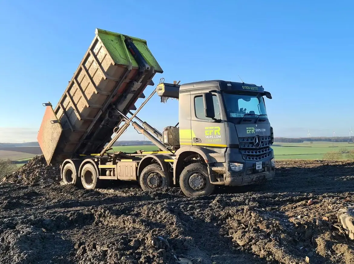 Grab lorry loading muck away
